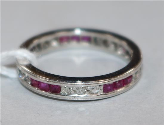 A white metal, ruby and diamond set full eternity ring, size L.